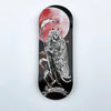 A black wooden fingerboard deck featuring a UV-printed graphic of a skull and a crescent moon.