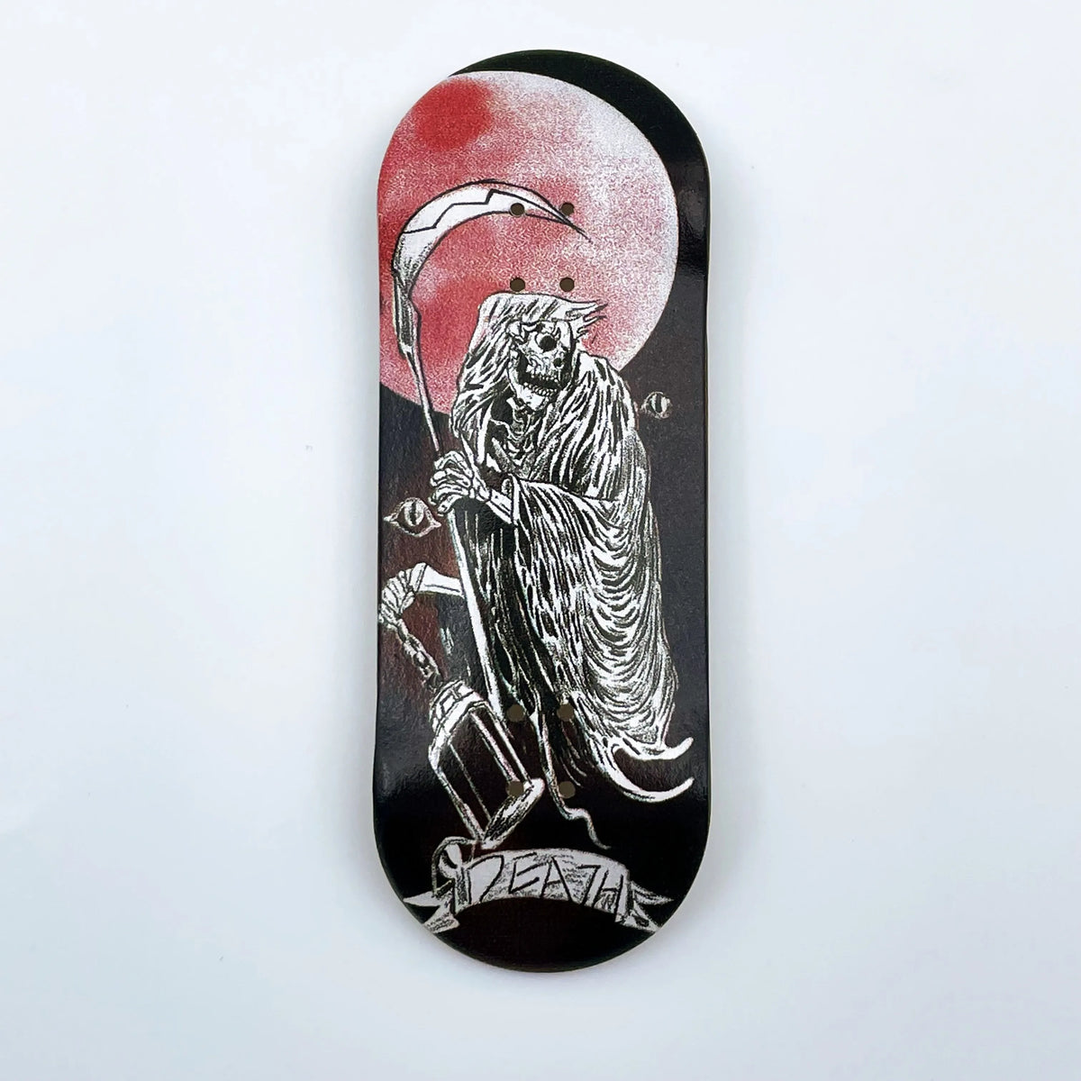 A black wooden fingerboard deck featuring a UV-printed graphic of a skull and a crescent moon.