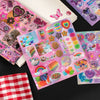 A collection of colorful die-cut stickers featuring cute and vintage designs on a sheet of paper.