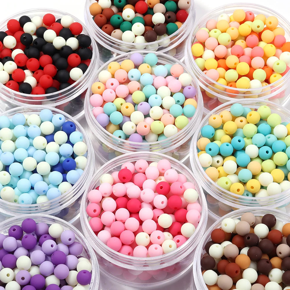 A collection of various colored matte acrylic beads in different shades and sizes for DIY jewelry making