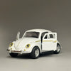 A white diecast model of a classic retro Beetle with gold accents, shown in profile.