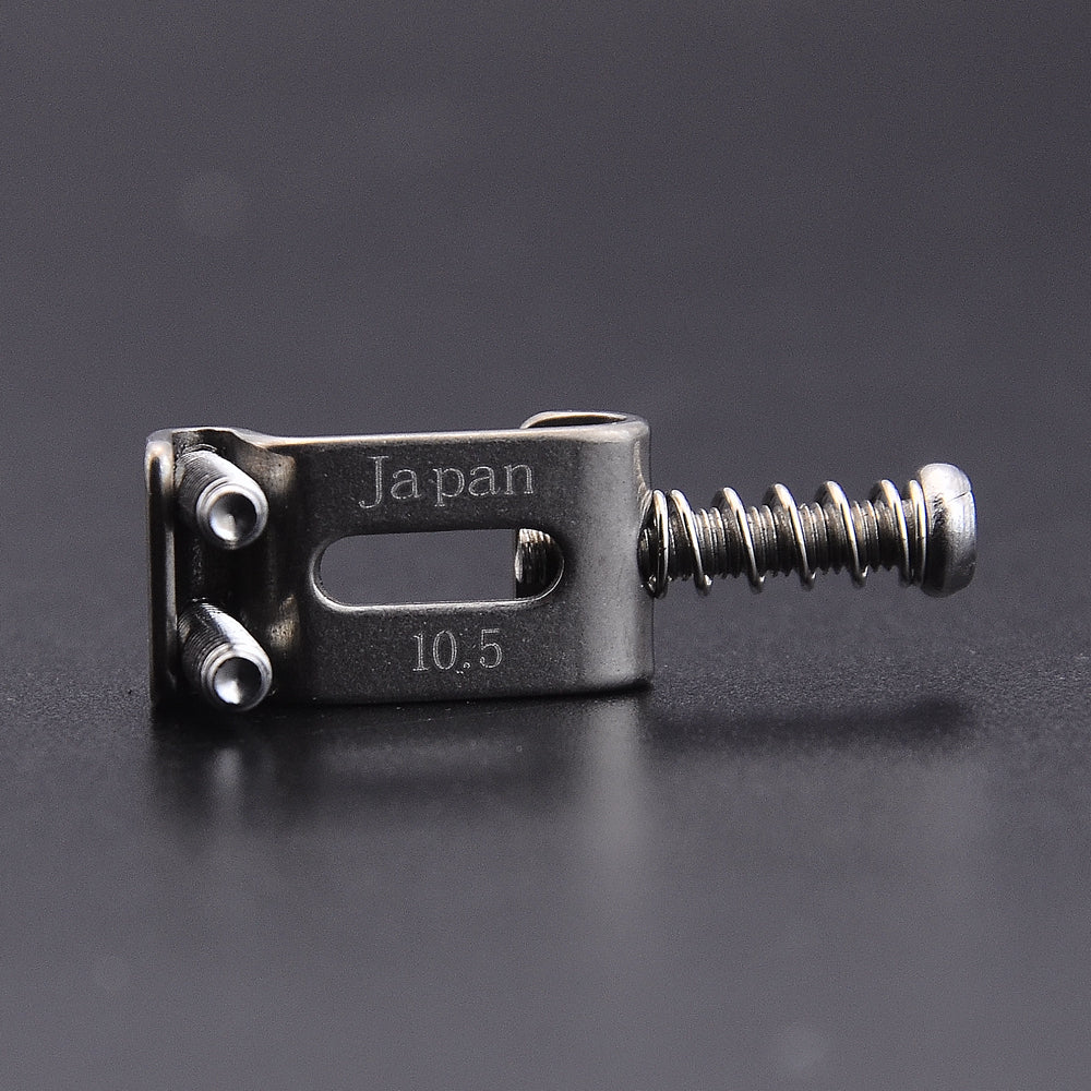 A titanium alloy electric guitar bridge saddle set with a 10.5mm size and Japanese engraving.