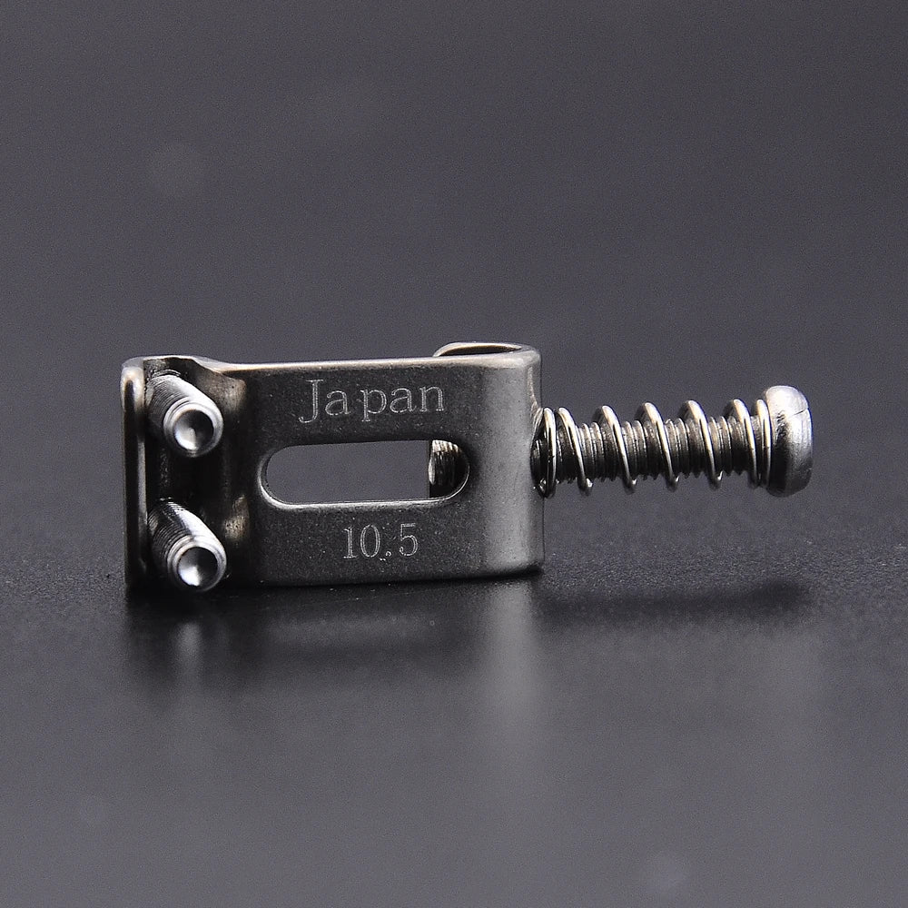 A titanium alloy electric guitar bridge saddle set with a 10.5mm size and Japanese engraving.