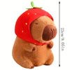 A brown capybara plush toy with a red hood and four small baby plush toys.