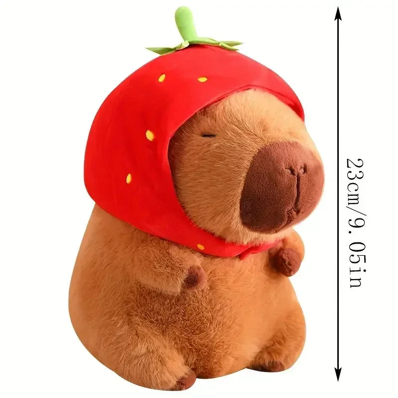 A brown capybara plush toy with a red hood and four small baby plush toys.