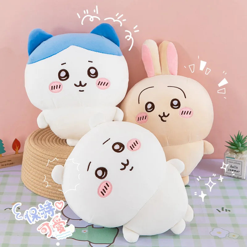 A set of three Chiikawa plush dolls, including Hachiware and Usagi, in white and light beige colors, resting on a purple chec