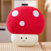 A bright red mushroom plush toy with white polka dots sits on a light wooden surface.