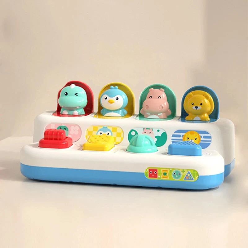 A white toy featuring five colorful animal pop-up figures in individual compartments for cause and effect learning.