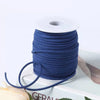A roll of dark blue velvet faux suede braided ribbon for crafting and gift wrapping