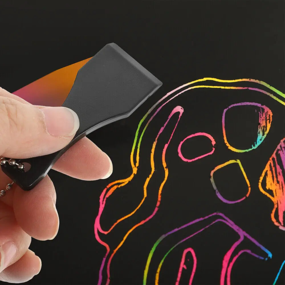 A hand holds a black plastic lottery scratcher tool against a colorful outline of a skull and figure on a dark background.