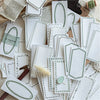 A collection of vintage scrapbooking paper sheets featuring delicate green and white floral patterns for journaling and craft