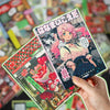 A hand holds a colorful decorative cut film sticker set featuring an illustration of a pink-haired anime girl.