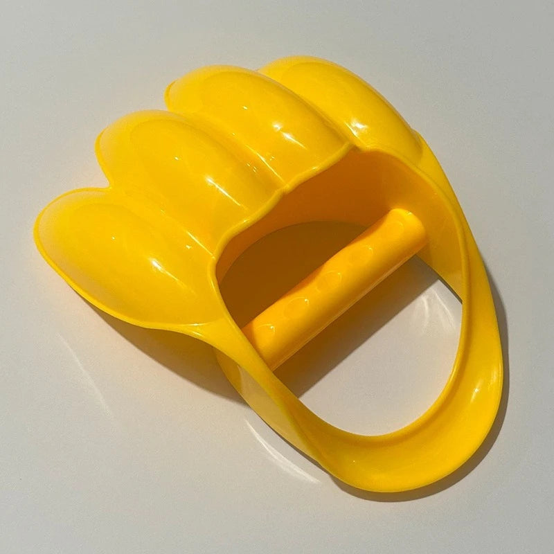 A bright yellow dinosaur claw sand digging toy for kids, shown from above.