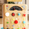 A wooden Montessori busy board featuring various lights, switches, and functions for early education.