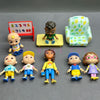 A collection of playful cartoon PVC figurines featuring diverse characters and a watermelon school bus design.