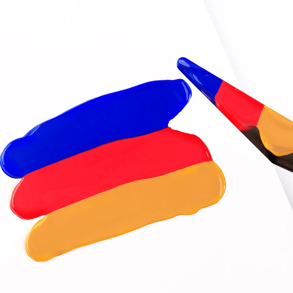 A set of three layered acrylic paint strokes in blue, red, and yellow on a white background.