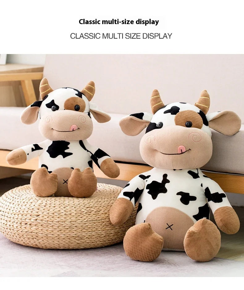 A classic multi-size display of soft plush cow dolls in black and white patterns.