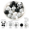 A white bowl filled with black and white silicone beads shaped like pandas, including various sizes and styles.