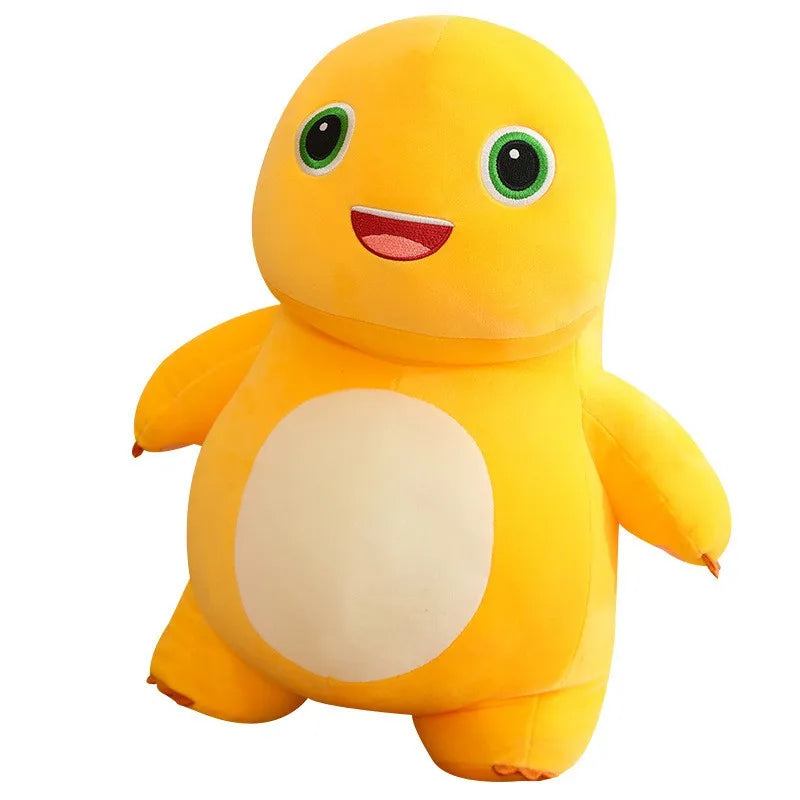 A bright yellow, smiling dinosaur plush toy with large green eyes and a light beige belly.