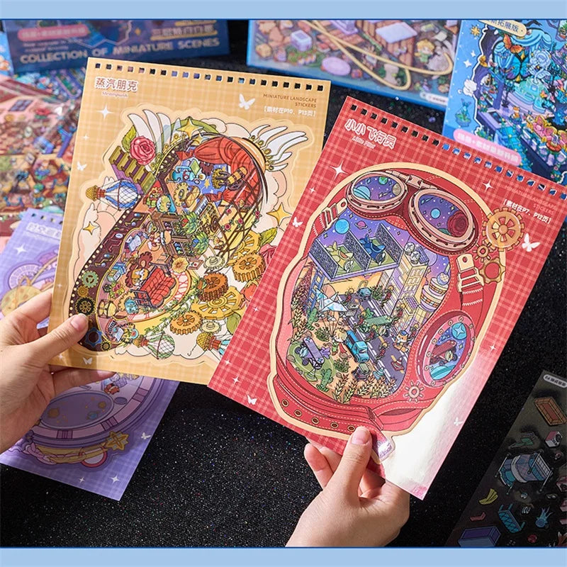 A hand holds two colorful sticker pads featuring detailed 3D cartoon scenes for scrapbooking and journaling.