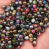 A close-up view of a 340-piece set of golden gradient glass beads in various colors and finishes.
