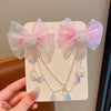 Pink mermaid princess hair clip featuring a butterfly bow and dangling pearl and iridescent beads