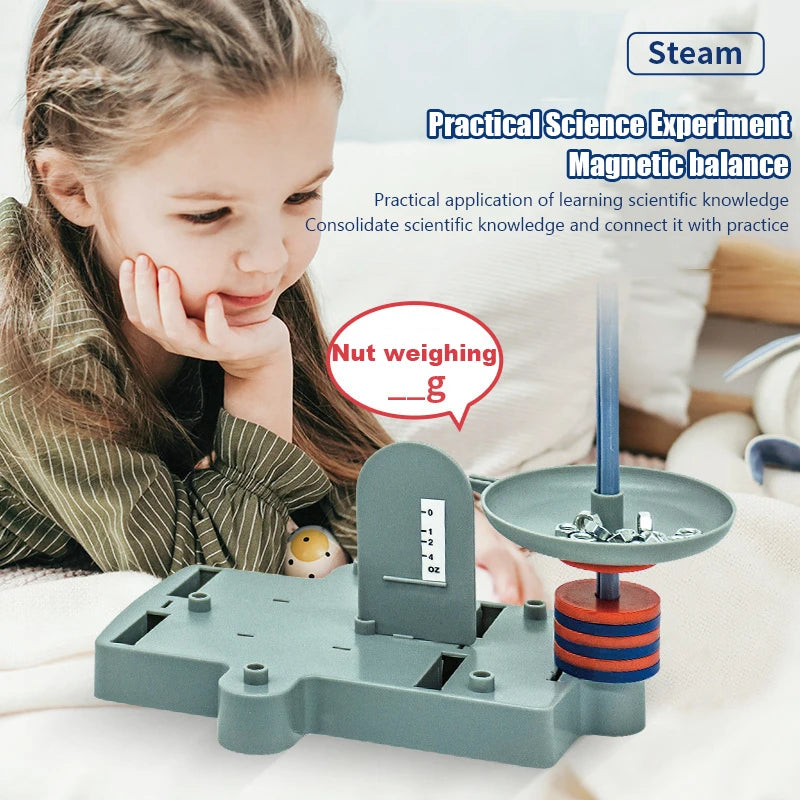 A girl is demonstrating a practical science experiment using a magnetic balance kit to measure the weight of a nut.