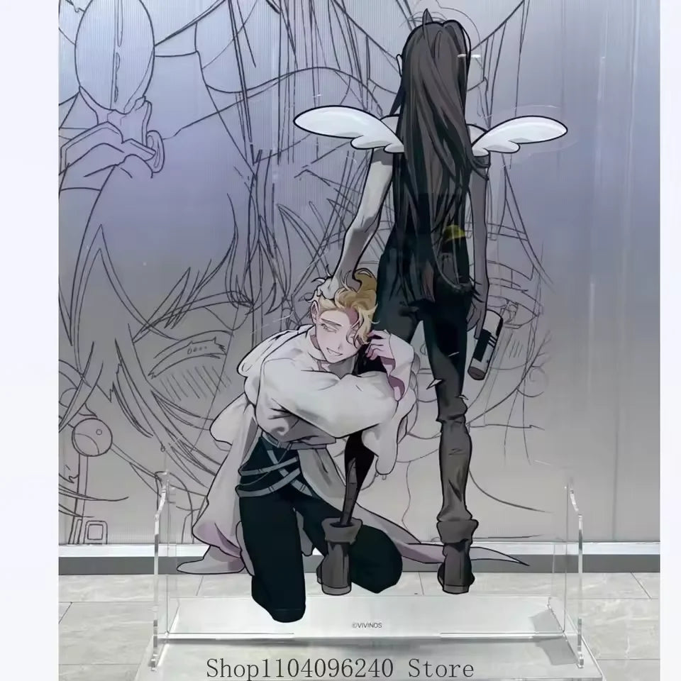 Acrylic figure of a dark-haired female character with white wings and a blonde male character in a stylized drawing backgroun