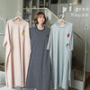 A women's short-sleeve striped lounge dress in pink and white stripes displayed on a hanger.