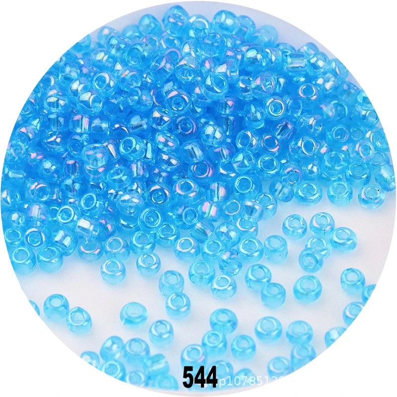 A pile of bright blue Czech glass seed beads for jewelry making
