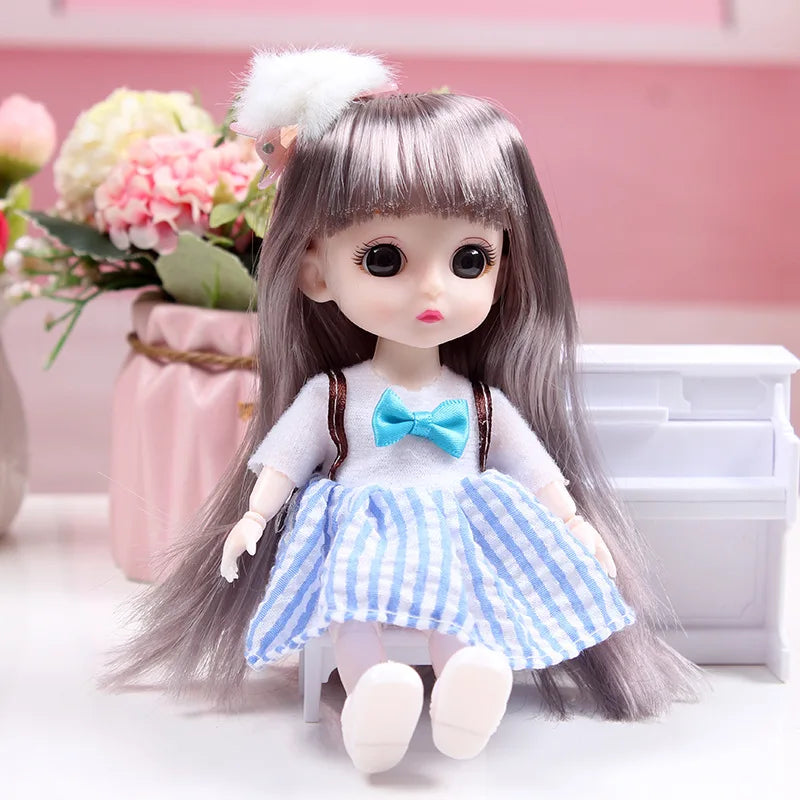 A 17cm articulated princess doll with long gray hair and a blue and white striped dress sitting on a white surface.