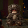 A collectible figure resembling a monster with shaggy gray fur and pink accents.