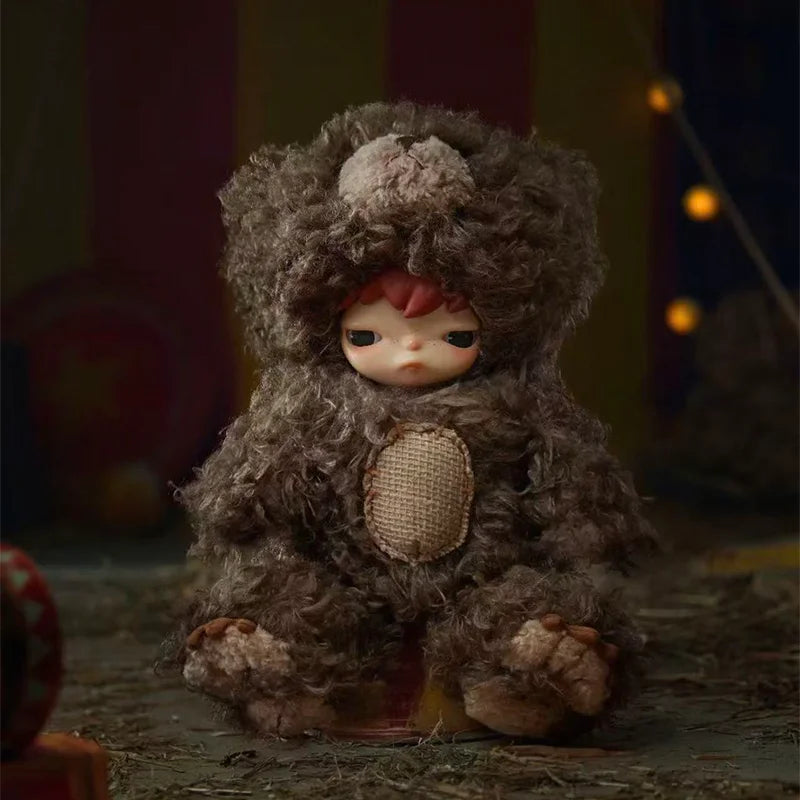 A collectible figure resembling a monster with shaggy gray fur and pink accents.