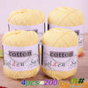Four balls of yellow cotton knitting yarn for crochet and handmade projects