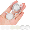 A hand holds a clear silicone baby pacifier and clip set decorated with sparkling rhinestones.