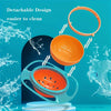 An orange splash-proof gyro bowl with a lid is shown being washed under running water.