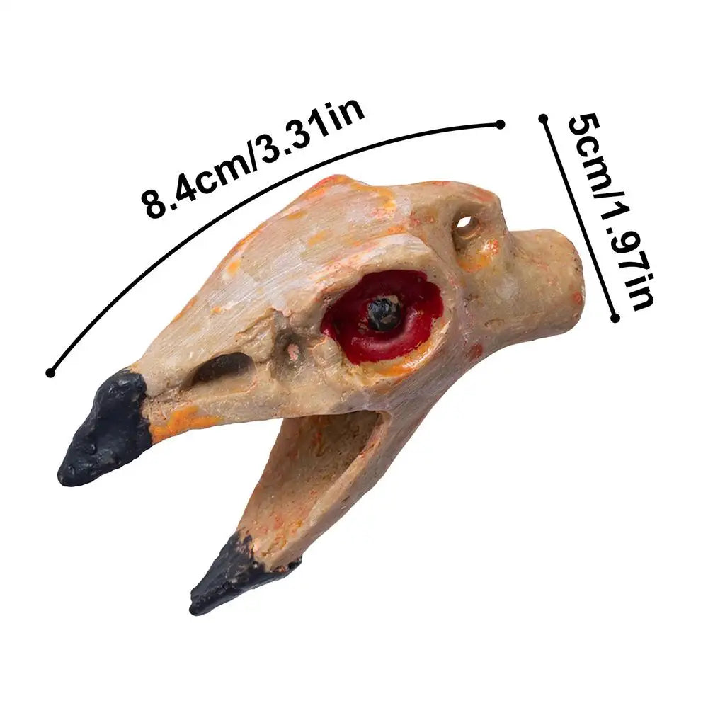 A ceramic Aztec skull whistle with measurements indicating its size.
