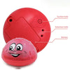 A red, spherical bath toy with suction and induction holes, featuring a smiling face and battery compartment.