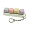 Colorful acrylic keycap fidget keychain featuring four clicky key buttons in pastel colors.