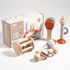 A box of wooden musical instrument toys including a wooden musical instrument toy set for sensory play.