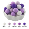A bowl filled with 50 silicone beads in various shades of purple and white for DIY jewelry making