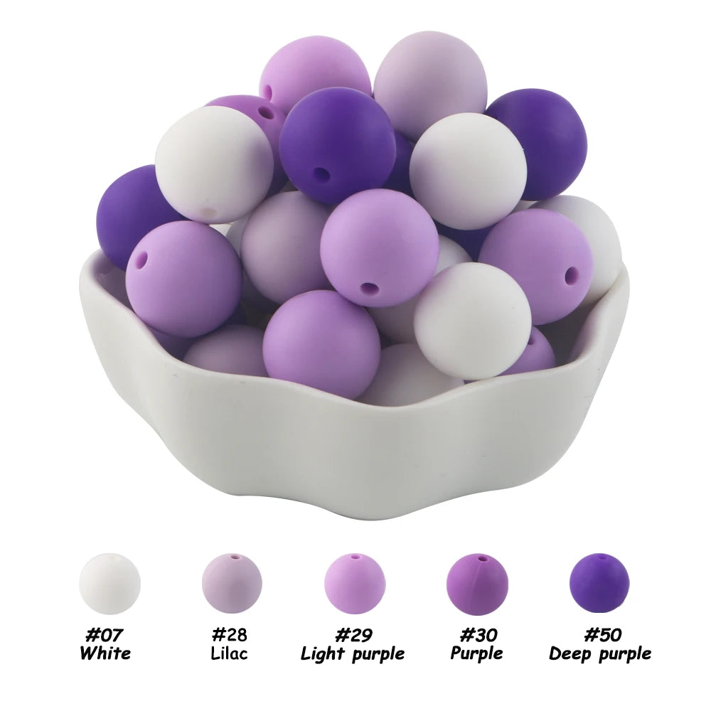 A bowl filled with 50 silicone beads in various shades of purple and white for DIY jewelry making