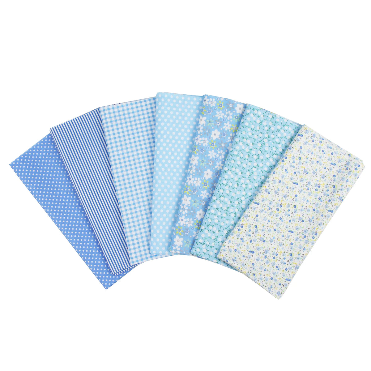 A pack of seven light blue and white patterned cotton fabric squares for quilting and patchwork