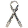 A beige woven guitar strap with blue floral embroidery and leather accents.