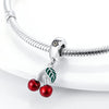 A silver fruit charm bead set featuring cherries and a leaf, attached to a sterling silver bracelet chain.