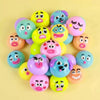 A collection of colorful, moldable dog face squishy sensory toys in various shades of pink, yellow, and blue.