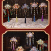 A family portrait featuring ornate metal phoenix crown models and decorative hanging elements.