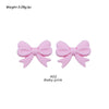 Two pink silicone bow tie beads used for jewelry making and craft projects