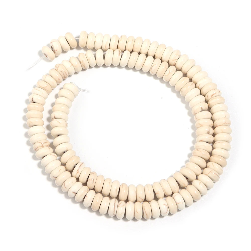A strand of natural light beige turquoise stone beads coiled into a circular necklace shape.