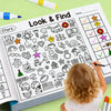 A toddler is coloring in a Look & Find activity book featuring various stars and objects.